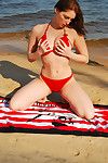 Engaging and attractive brunette teen with hawt figure is demonstrating her body on the beach