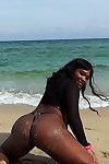 Bootylicious ebony babe posing in thong underclothes and sheer dominant outdoor
