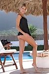 Baring her sexy sheer ebony top beautiful blond Iveta Vale plays uncovered by the swimming pool