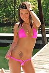 Beautiful babe outdoors in a little pink bikini that hugs her tits