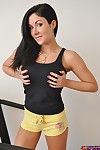 Sporty brunette babe Sweet Krissy in yellow shorts flashes her huge titties