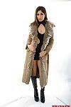 Sahara Knite takes off her fur coat to pose in tight black dress and boots